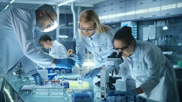 A team of diverse scientists collaborating in a modern laboratory